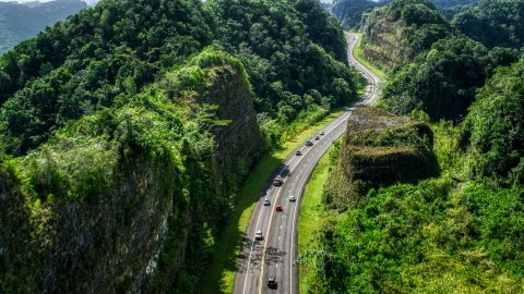 Light traffic on a highway lush green mountains, Karst Forest, Puerto Rico Aerial Stock Photos | AX101_082.0000065F