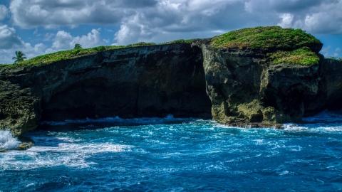 Crystal blue water and a shallow sea cave in Arecibo, Puerto Rico  Aerial Stock Photos | AX101_165.0000270F