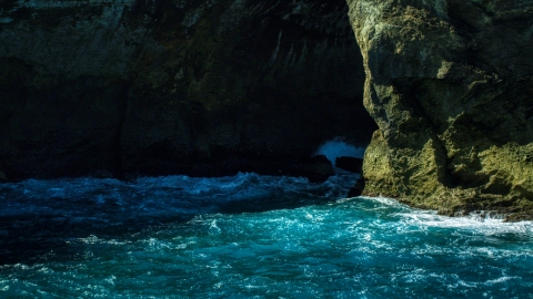 AX101_166.0000124F - Aerial stock photo of A coastal sea cave in rock formations in the Caribbean, Arecibo, Puerto Rico