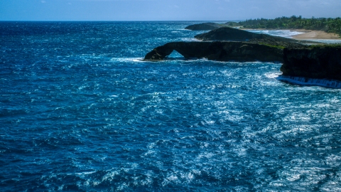 Arched rock formation in crystal blue water, Arecibo, Puerto Rico Aerial Stock Photos | AX101_168.0000000F