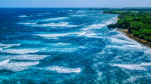 Ocean waves rolling toward a Caribbean island coast in Vega Baja, Puerto Rico Aerial Stock Photos | AX101_198.0000000F