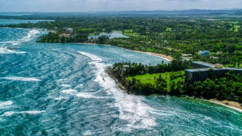 AX101_213.0000000F - Aerial stock photo of Beachfront island community by blue water, Dorado, Puerto Rico