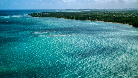 Caribbean island coastal community seen across blue water in Dorado, Puerto Rico Aerial Stock Photos | AX101_216.0000000F