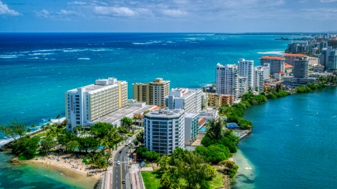 Hotels and high-rises on the coast, and crystal blue water, San Juan, Puerto Rico  Aerial Stock Photos | AX102_002.0000000F