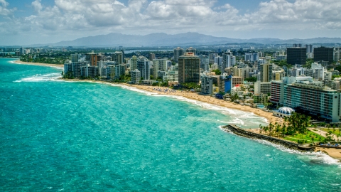 Beachside hotels and high-rises beside crystal blue waters, San Juan, Puerto Rico Aerial Stock Photos | AX102_003.0000156F