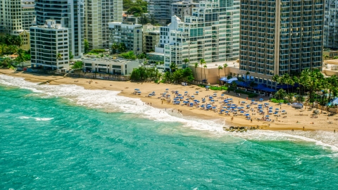 Tourists on a beach enjoying clear blue waters, San Juan, Puerto Rico Aerial Stock Photos | AX102_004.0000000F