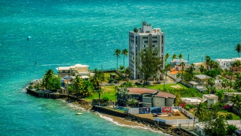 AX102_007.0000151F - Aerial stock photo of Oceanfront homes and a kite surfer in San Juan, Puerto Rico