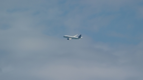 A passenger jet flying over Carolina, Puerto Rico Aerial Stock Photos | AX102_013.0000134F