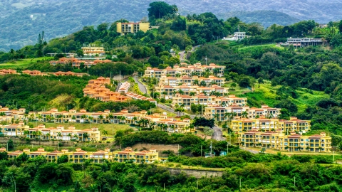 Condos on a tree covered hillside, Rio Grande, Puerto Rico  Aerial Stock Photos | AX102_045.0000108F