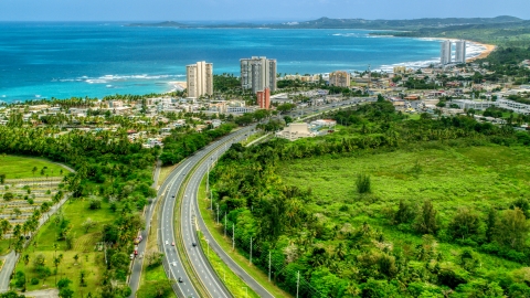 AX102_049.0000000F - Aerial stock photo of Beachside community and condos by crystal blue waters, Luquillo, Puerto Rico