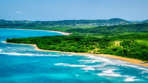 AX102_053.0000000F - Aerial stock photo of Jungle and beach beside clear blue Caribbean waters, Luquillo, Puerto Rico