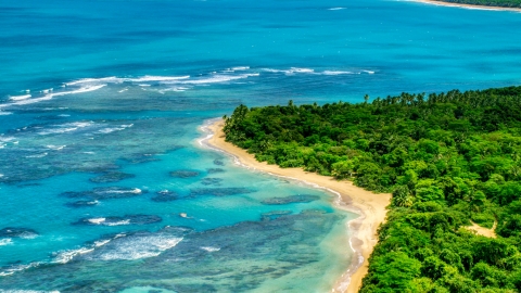 AX102_054.0000000F - Aerial stock photo of Reefs in the crystal blue waters along the Caribbean beach, Luquillo, Puerto Rico 