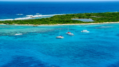 Catamarans in tropical blue waters near reefs and an island, Rada Fajardo, Puerto Rico Aerial Stock Photos | AX102_074.0000000F