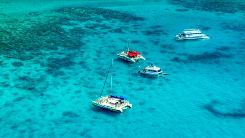 Catamarans in tropical blue Caribbean waters near reefs in Rada Fajardo, Puerto Rico Aerial Stock Photos | AX102_074.0000165F