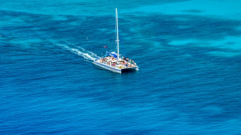 AX102_076.0000000F - Aerial stock photo of A catamaran in crystal clear blue tropical waters, Rada Fajardo, Puerto Rico 