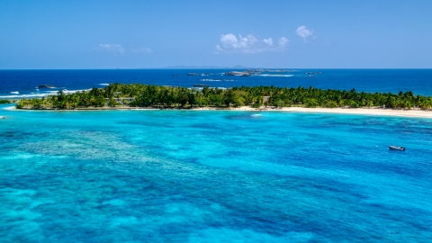 High above tropical blue waters near a small island, Puerto Rico  Aerial Stock Photos | AX102_083.0000278F