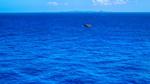 Tiny rocky island in sapphire blue ocean, Puerto Rico  Aerial Stock Photos | AX102_090.0000165F