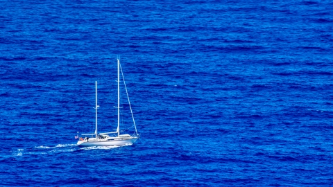 Sail boat in sapphire blue waters, Culebra, Puerto Rico  Aerial Stock Photos | AX102_105.0000100F