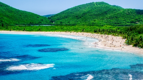 Beachgoers on a white sand Caribbean beach by sapphire blue waters, Culebra, Puerto Rico  Aerial Stock Photos | AX102_112.0000000F