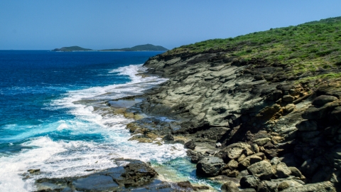 AX102_126.0000234F - Aerial stock photo of Waves crashing into a rugged island coast, Culebra, Puerto Rico