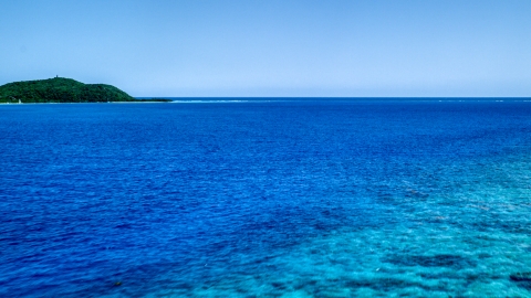 AX102_132.0000290F - Aerial stock photo of Turquoise ocean waters near a small island, Culebra, Puerto Rico