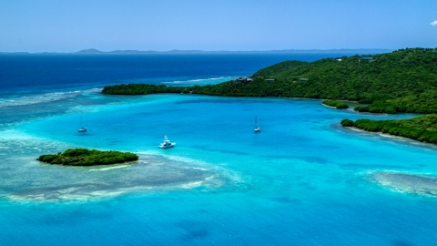 AX102_136.0000000F - Aerial stock photo of Fishing boat and sailboats in turquoise blue waters along the island coast, Culebra, Puerto Rico 