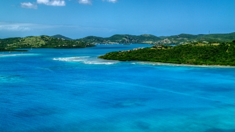 Hilltop homes overlooking sapphire blue waters near a coastal town, Culebra, Puerto Rico  Aerial Stock Photos | AX102_138.0000238F