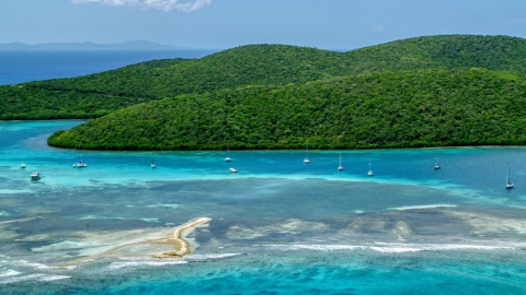 AX102_140.0000148F - Aerial stock photo of Sailboats in turquoise waters beside a Caribbean island coast, Culebra, Puerto Rico 