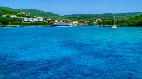 Ferry across a sapphire blue bay in Culebra, Puerto Rico  Aerial Stock Photos | AX102_148.0000239F