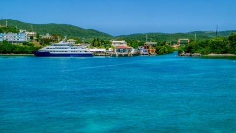 AX102_149.0000236F - Aerial stock photo of Docked ferry in sapphire blue bay by the coast, Culebra, Puerto Rico 