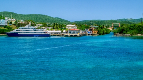 Ferry docked in sapphire waters by a waterfront town, and Culebra, Puerto Rico  Aerial Stock Photos | AX102_150.0000000F