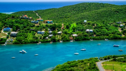 Oceanfront island homes by boats in sapphire waters, Culebra, Puerto Rico Aerial Stock Photos | AX102_155.0000201F