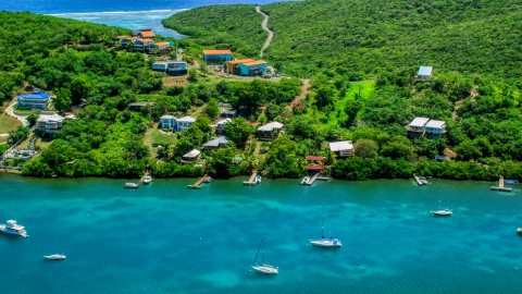 AX102_156.0000000F - Aerial stock photo of Island homes overlooking boats in the water in Culebra, Puerto Rico