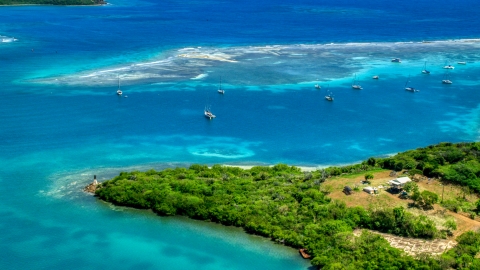 AX102_159.0000283F - Aerial stock photo of Sailboats near a reef in sapphire blue waters of a harbor Culebra, Puerto Rico 