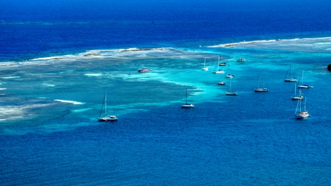 AX102_169.0000000F - Aerial stock photo of Sailboats anchored in the turquoise waters of the harbor, Culebra, Puerto Rico 