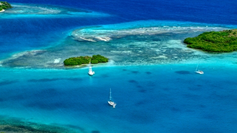 AX102_172.0000000F - Aerial stock photo of Boats near a reef in turquoise Caribbean waters, Culebra, Puerto Rico