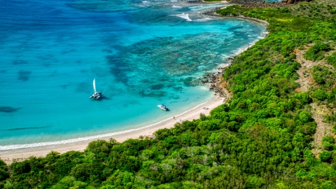 AX102_180.0000255F - Aerial stock photo of Pair of boats beside a white sand beach on the Caribbean island of Culebrita, Puerto Rico 