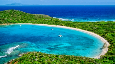 AX102_184.0000156F - Aerial stock photo of Catamarans in turquoise waters beside a white sand Caribbean beach, Culebrita, Puerto Rico