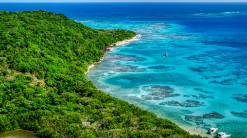 AX102_185.0000000F - Aerial stock photo of Sailboat and reefs by a tree filled island coast, Culebrita, Puerto Rico 