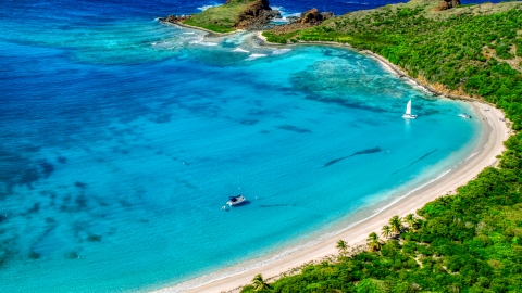 AX102_187.0000000F - Aerial stock photo of Catamarans beside a Caribbean island beach in Culebrita, Puerto Rico