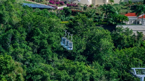 Gondolas above trees near hillside homes, Charlotte Amalie, St. Thomas, US Virgin Islands  Aerial Stock Photos | AX102_211.0000226F