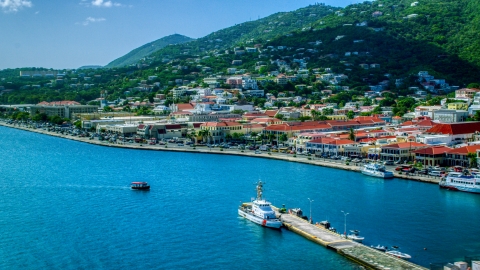 AX102_225.0000282F - Aerial stock photo of Island town and hills beside the harbor in Charlotte Amalie, St Thomas, the US Virgin Islands 