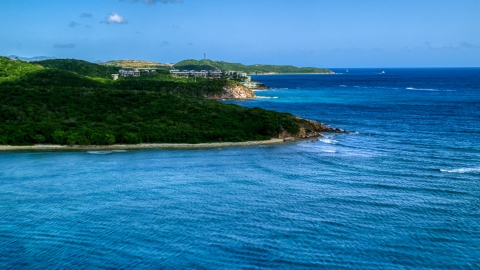 AX102_235.0000000F - Aerial stock photo of Oceanfront condominiums overlooking sapphire blue waters, Southside, St Thomas 