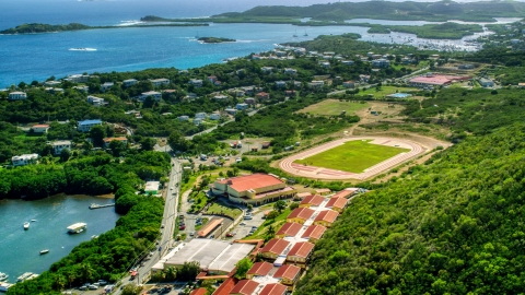 Island high school and track field near waterfront homes in East End, St Thomas, US Virgin Islands   Aerial Stock Photos | AX102_244.0000000F