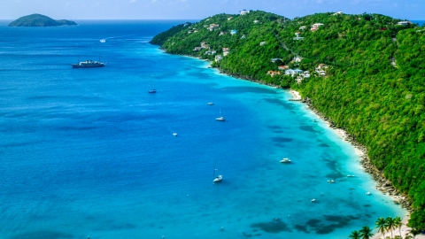 AX102_273.0000182F - Aerial stock photo of Sailboats in turquoise Caribbean waters and oceanfront island homes, Magens Bay, St Thomas 