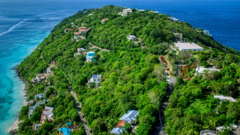 AX102_275.0000089F - Aerial stock photo of Hillside island homes overlooking the turquoise blue Caribbean waters, Magens Bay, St Thomas