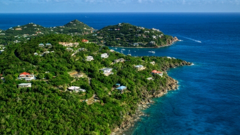 AX103_020.0000000F - Aerial stock photo of Hillside homes overlooking sapphire blue ocean waters, Cruz Bay, St John