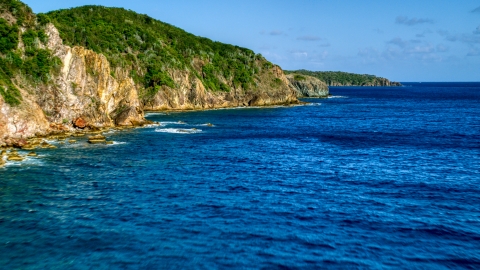 AX103_050.0000066F - Aerial stock photo of Coastal cliffs along sapphire blue Caribbean waters, Central, St John