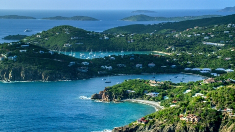 Hilltop and cliff top mansions along Caribbean blue waters, Cruz Bay, St John Aerial Stock Photos | AX103_060.0000202F