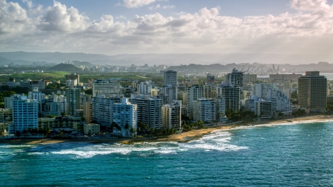 AX103_149.0000224F - Aerial stock photo of Condo complexes along Caribbean blue waters, San Juan, Puerto Rico